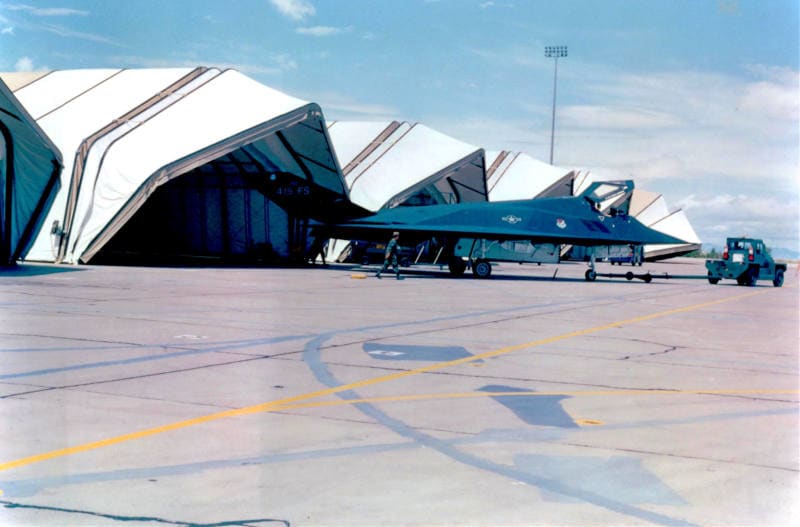 Clamshell aircraft hangars and tension fabric shelters